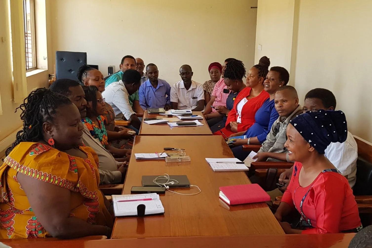 People gathered around a table for an ANM community meeting