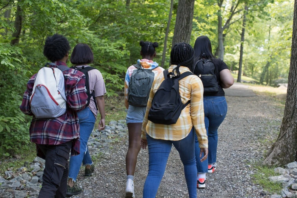 African Neurodiversity Movement A group of young women walking together on a wooded path