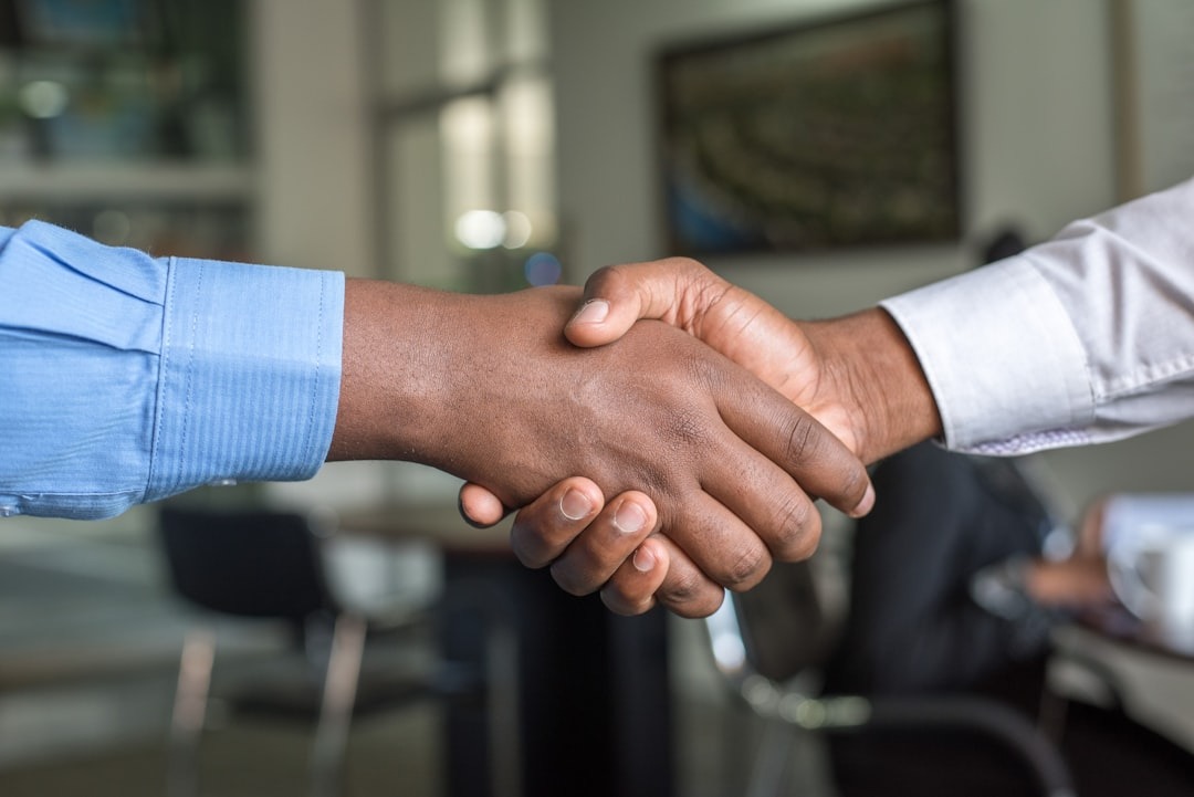 Two Black professionals shaking hands
